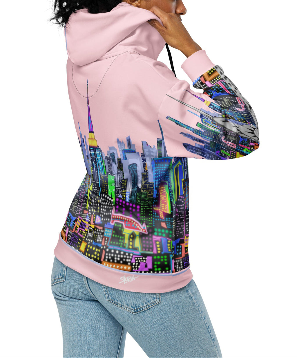 Person wearing a Loria NYC Art hoodie with a colorful cityscape design on a white background
