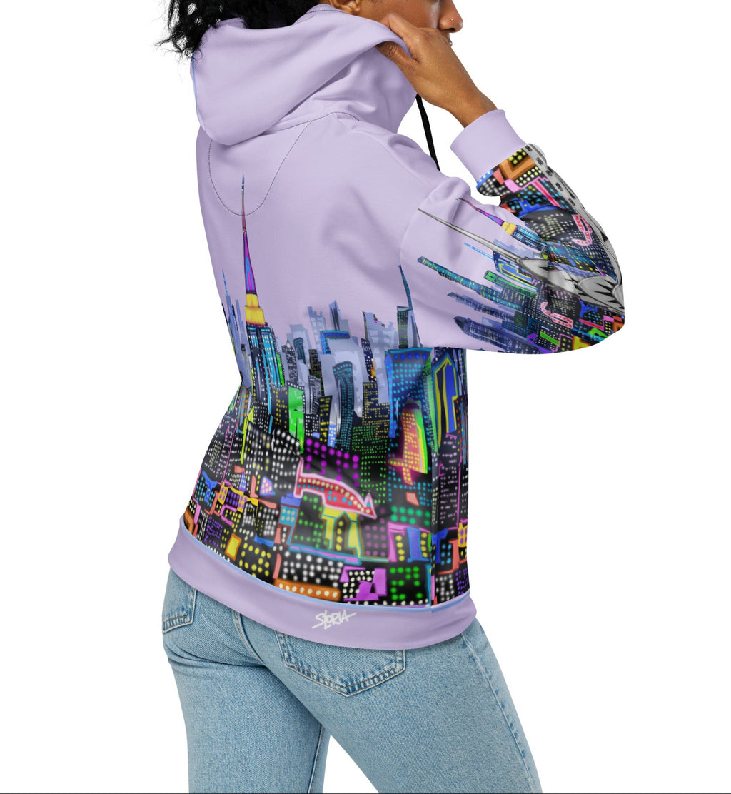 Person wearing a  Loria NYC Art hoodie with a colorful cityscape design on the back