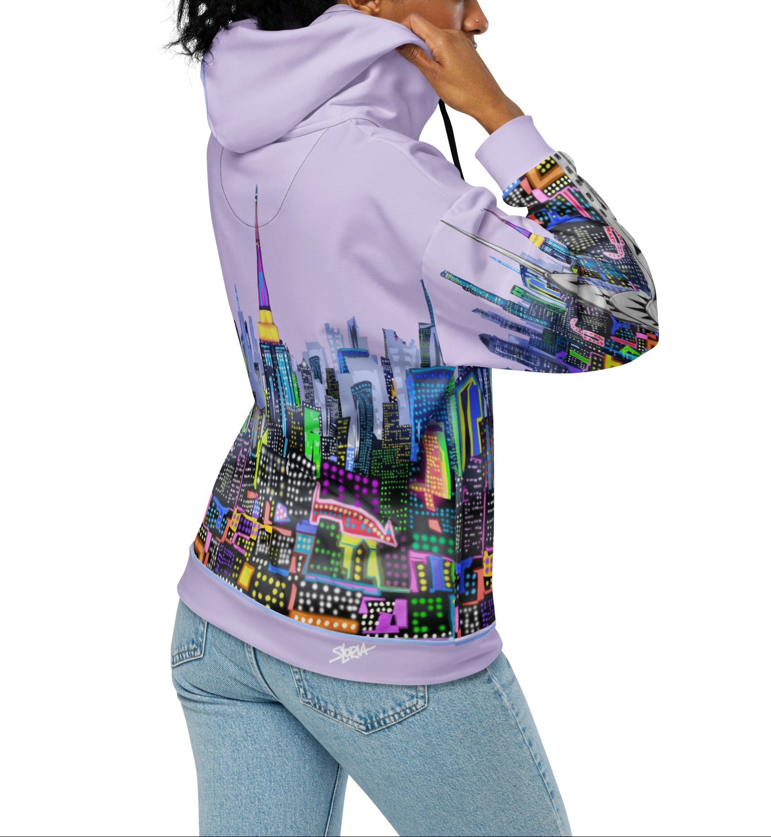 Person wearing a  Loria NYC Art hoodie with a colorful cityscape design on the back
