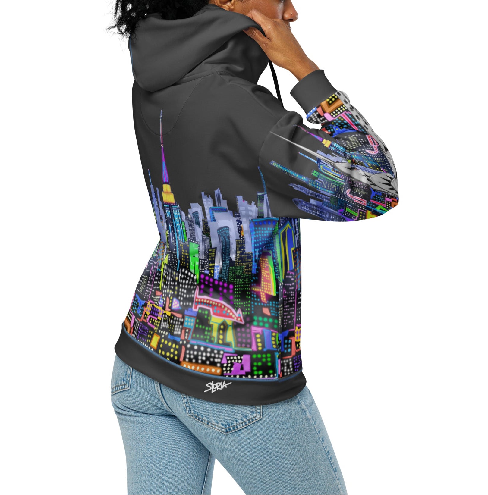 Person wearing a hoodie with a colorful cityscape Loria NYC Art design on a white background