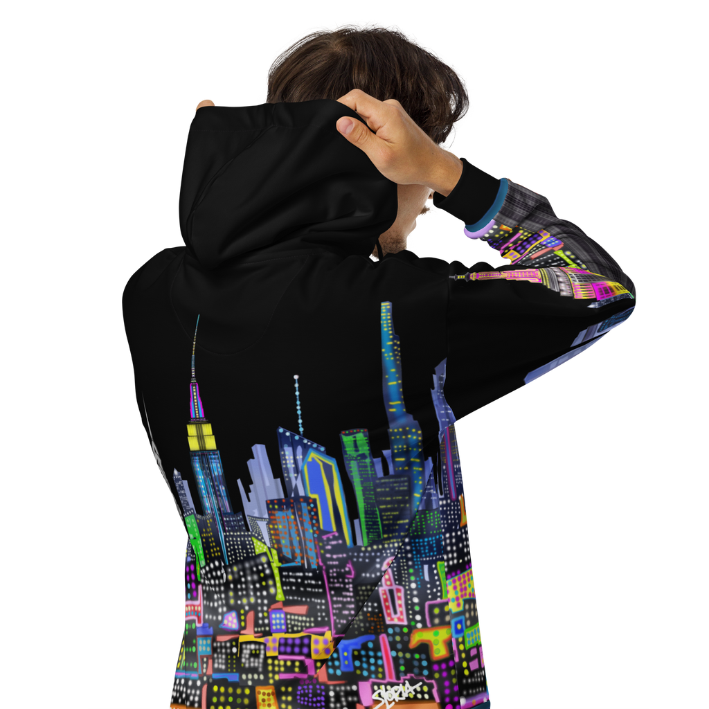 Person wearing a black Loria NYC Art hoodie with a colorful cityscape design on the back.