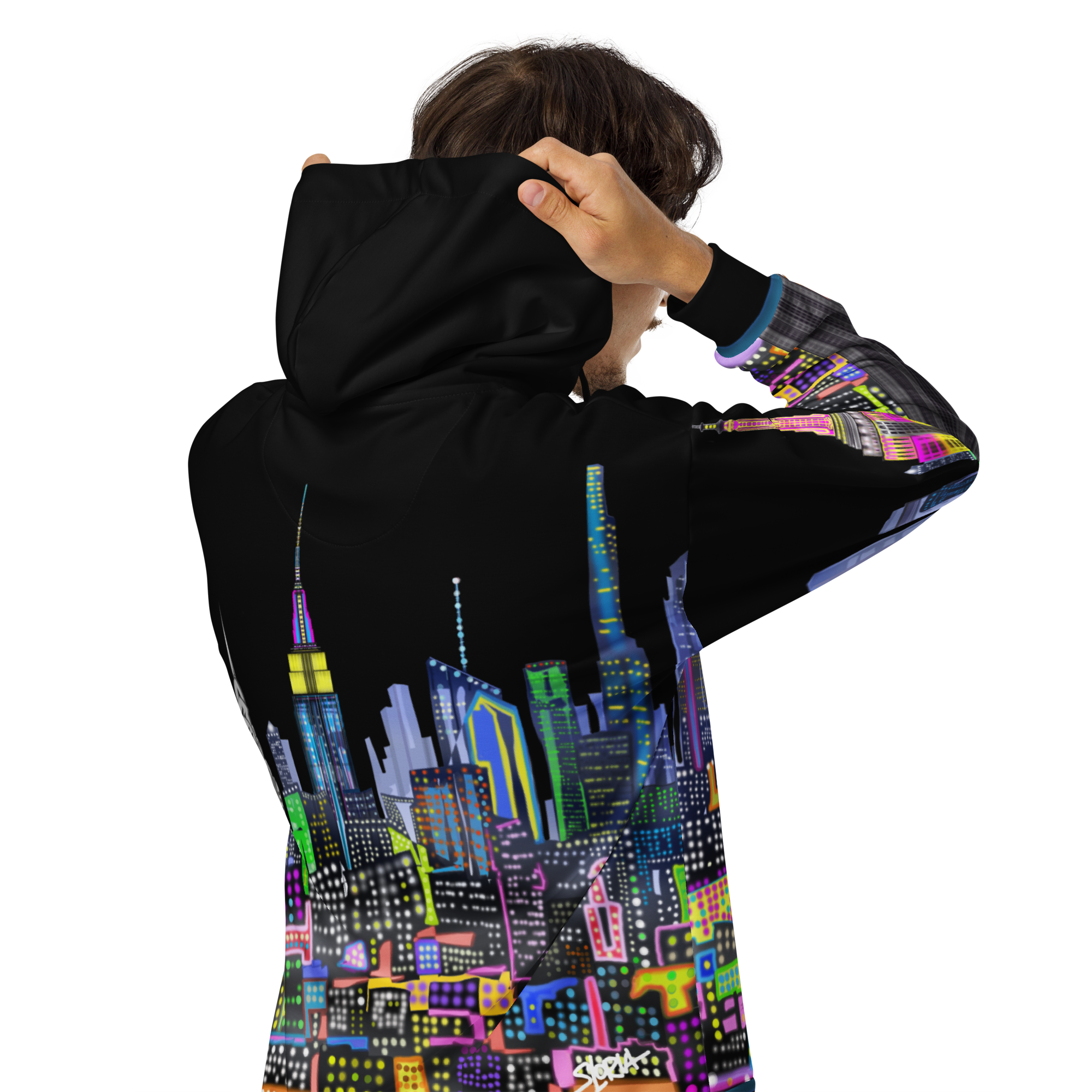 Person wearing a black Loria NYC Art hoodie with a colorful cityscape design on the back.