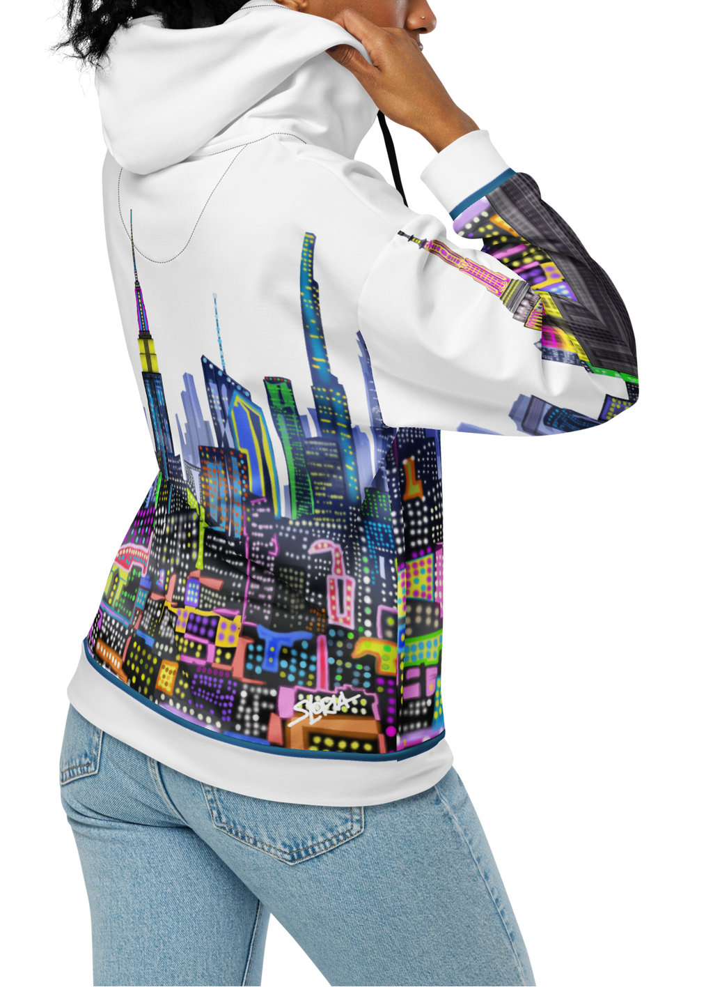 Person wearing a white hoodie with colorful cityscape Loria NYC Art design on the back, standing against a white background.