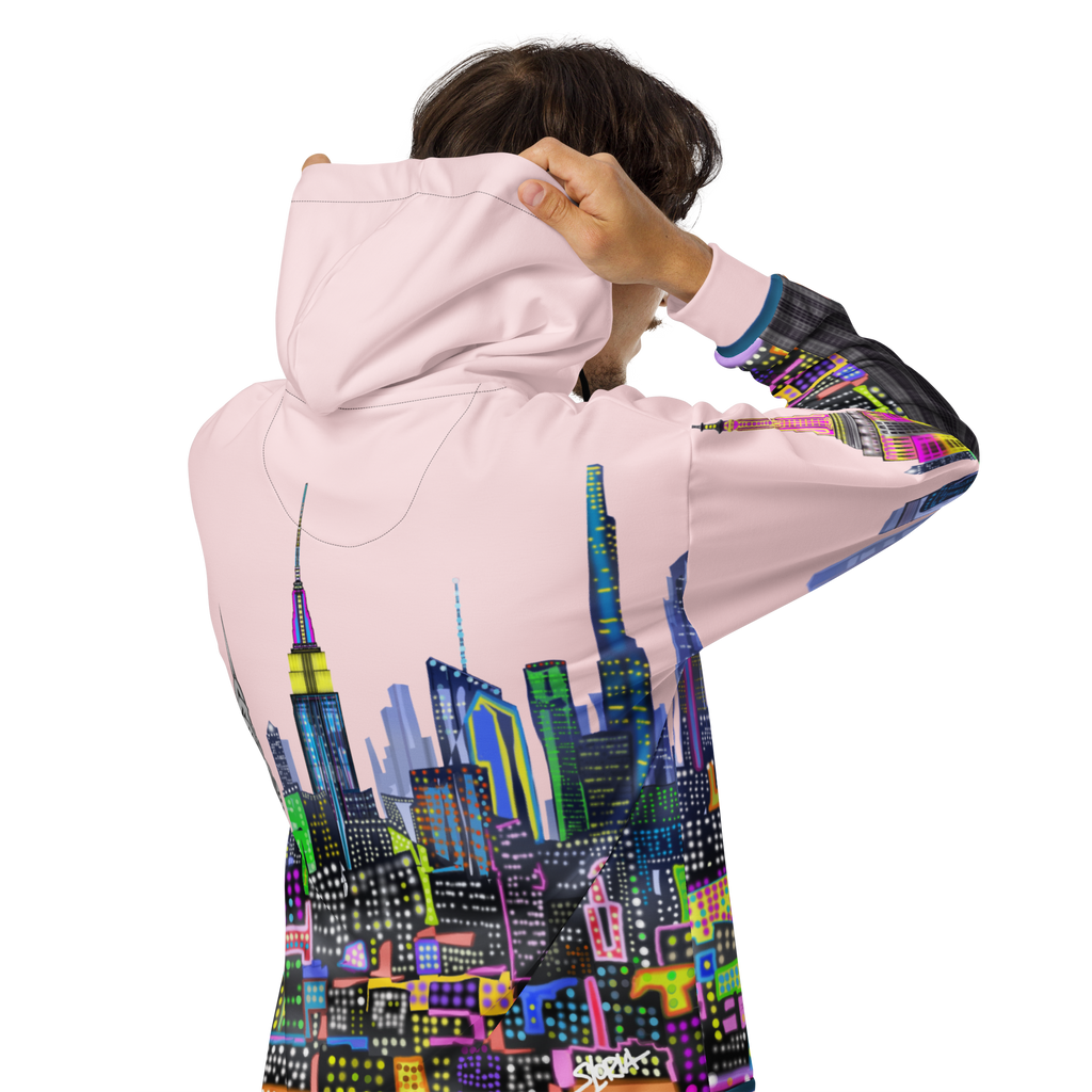 Person wearing a Loria NYC Art pink hoodie with a colorful cityscape design on the back.