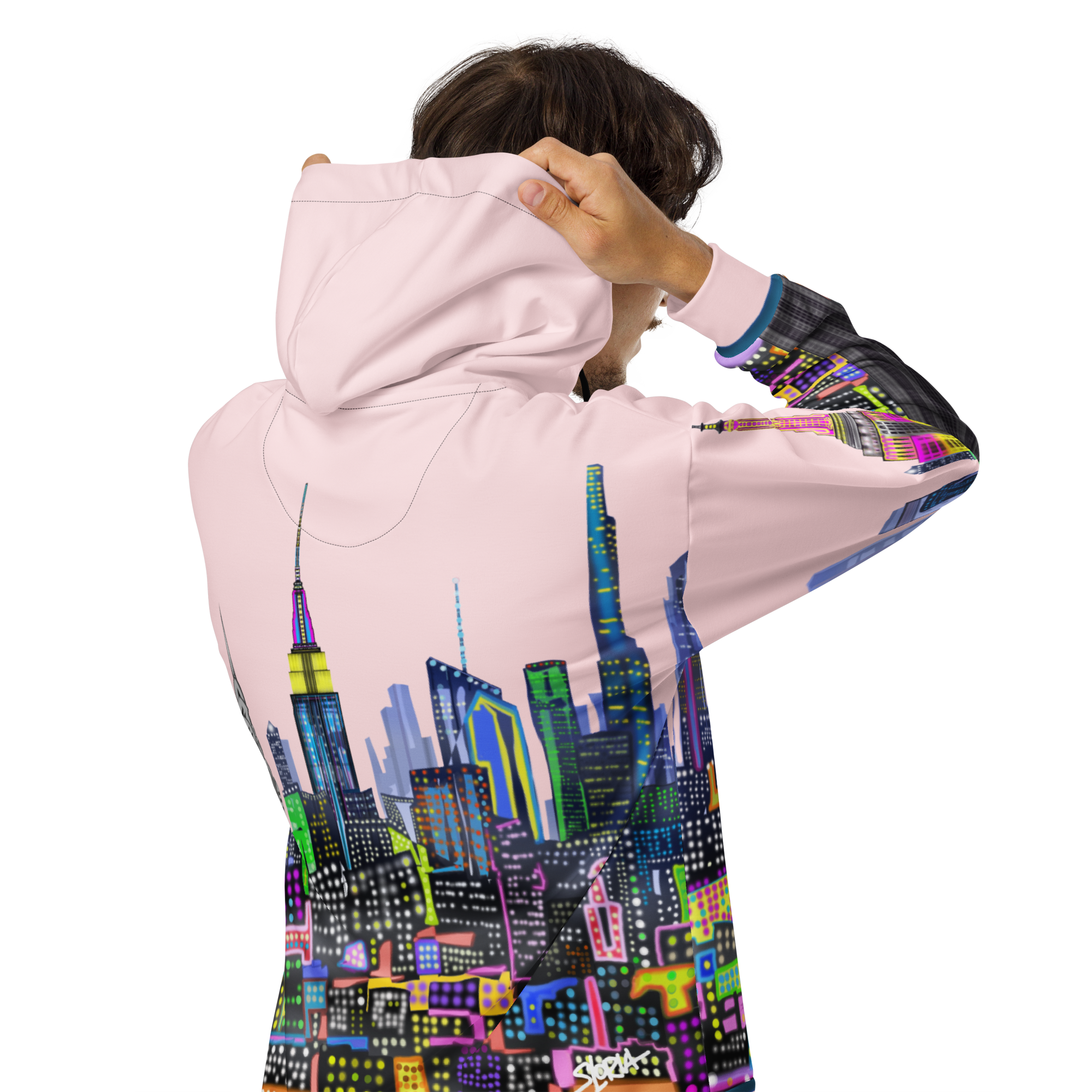 Person wearing a Loria NYC Art pink hoodie with a colorful cityscape design on the back.