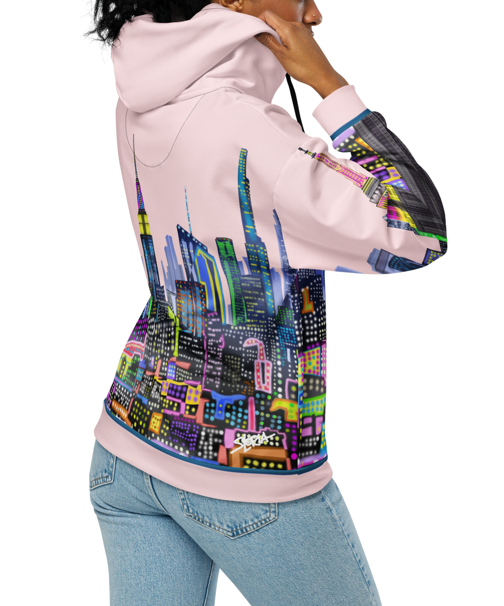 Person wearing a Loria NYC Art hoodie with a colorful cityscape design on a white background