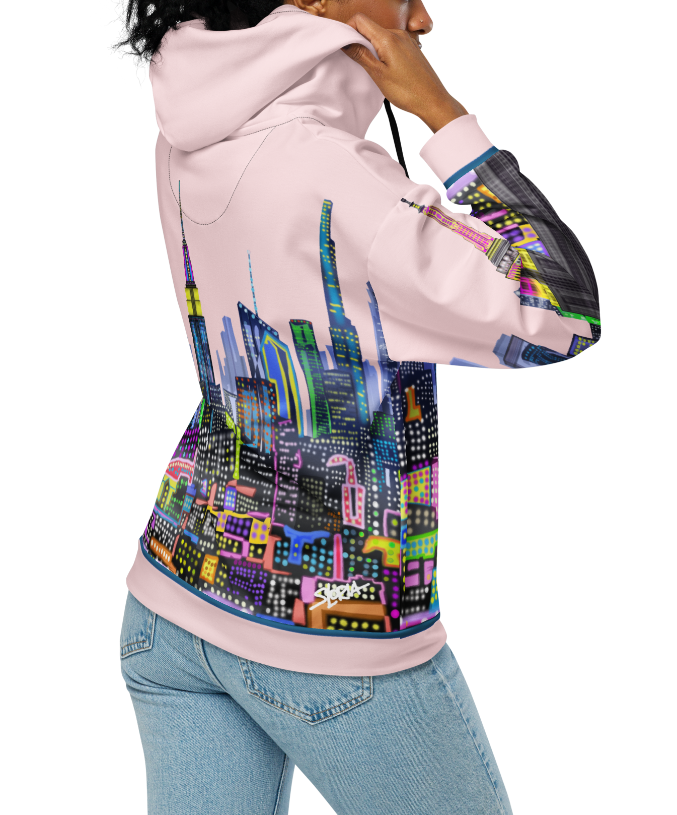 Person wearing a Loria NYC Art hoodie with a colorful cityscape design on a white background