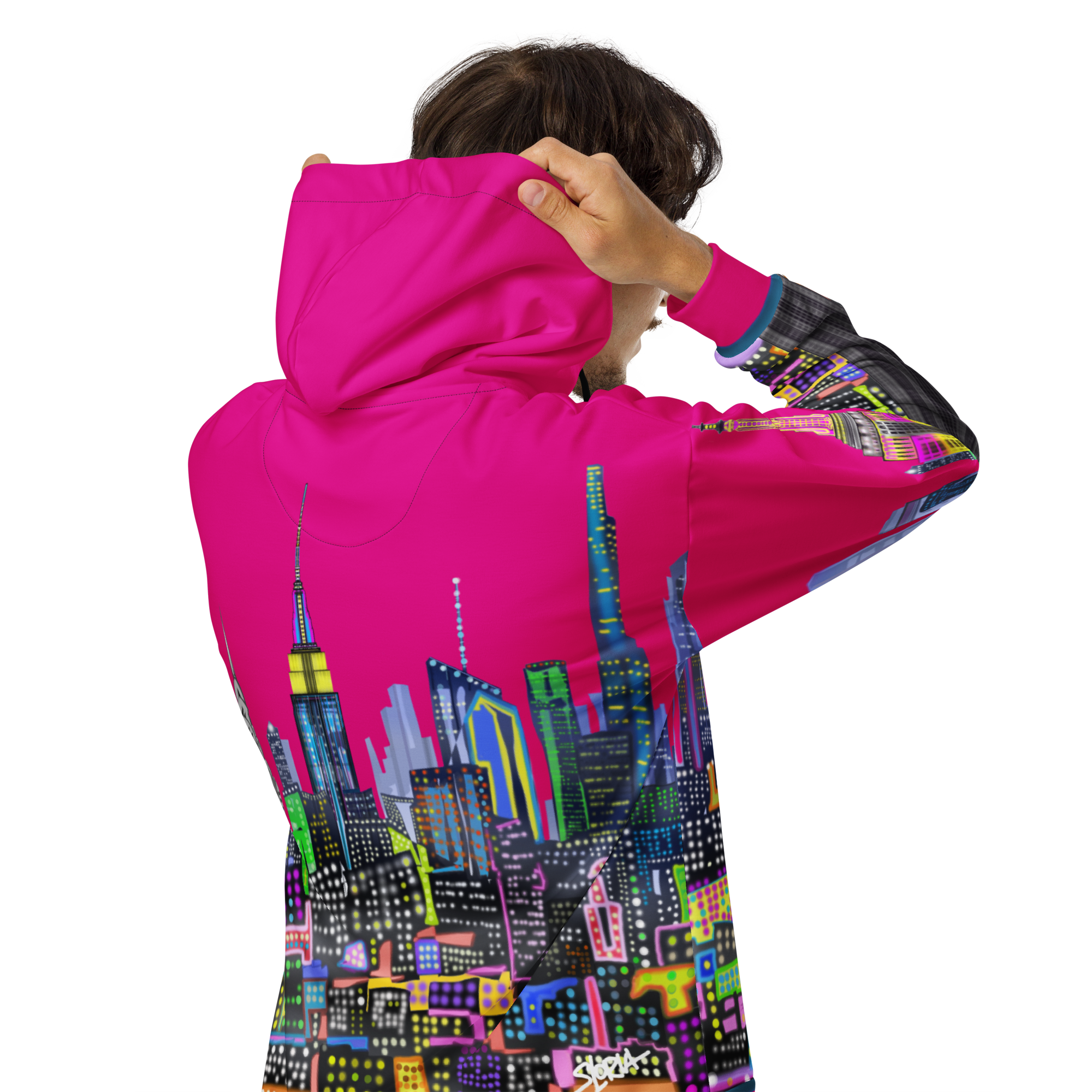 Person wearing a pink hoodie with a colorful Loria NYC Art  cityscape design on the back, on a white background.