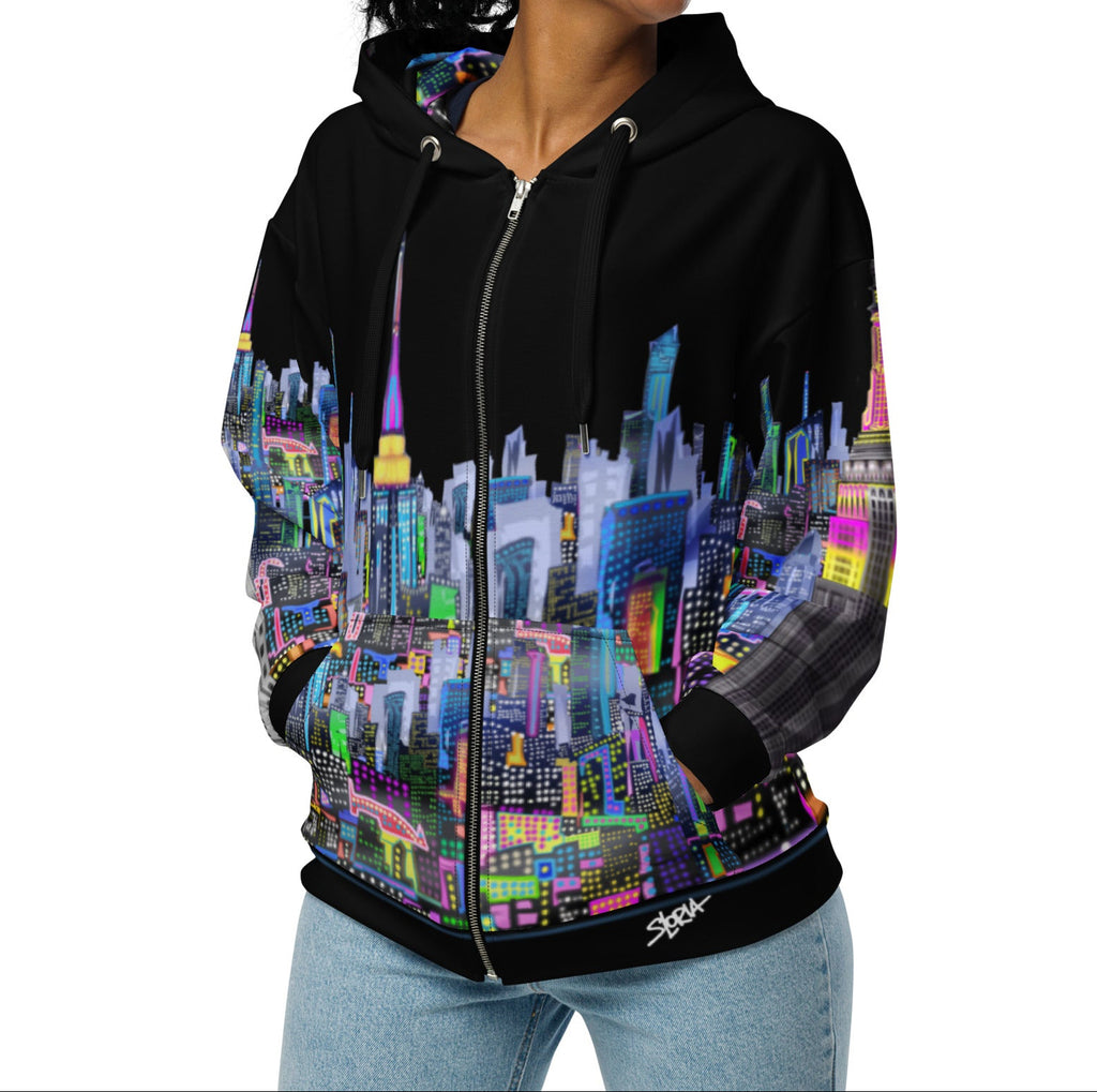 Girl modeling Black hoodie with colorful cityscape design by Loria NYC Art on a white background