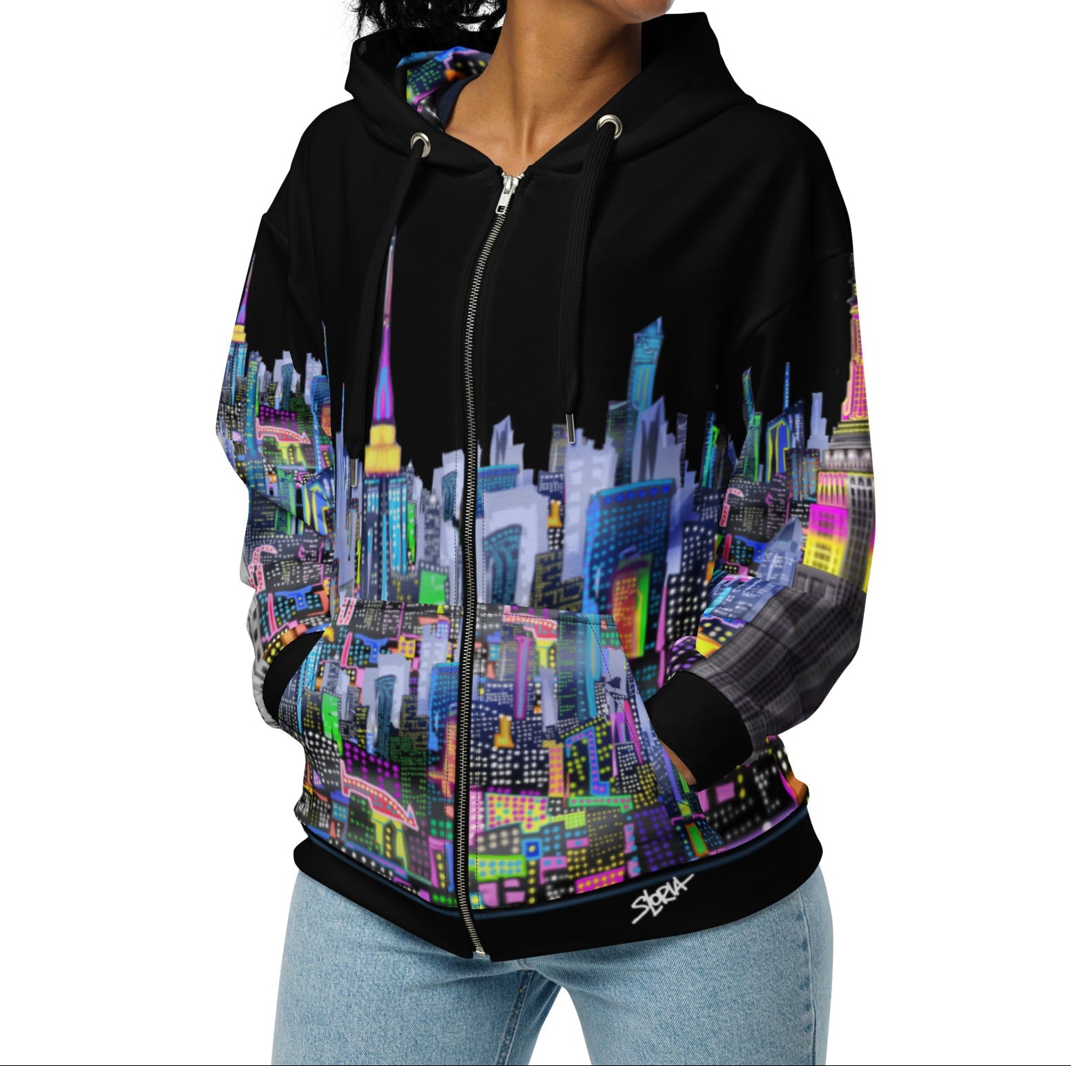 Girl modeling Black hoodie with colorful cityscape design by Loria NYC Art on a white background