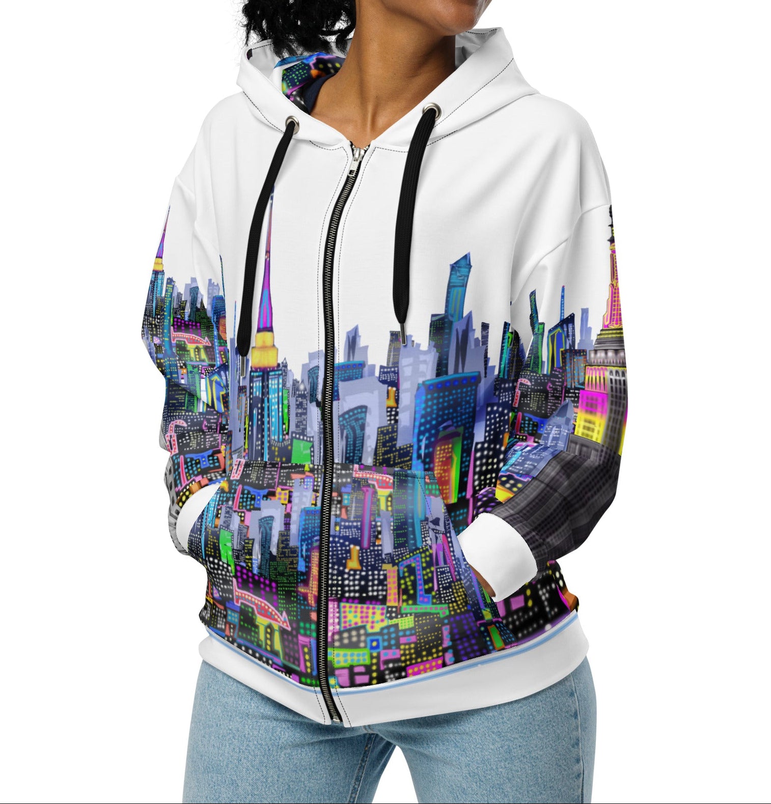 Woman wearing a white Loria NYC Art hoodie with a colorful cityscape design on a white background