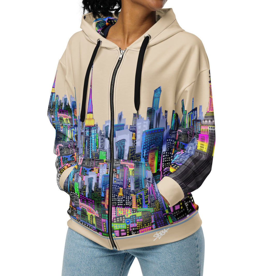 Woman wearing a hoodie with a colorful cityscape Loria NYC Art design on a white background