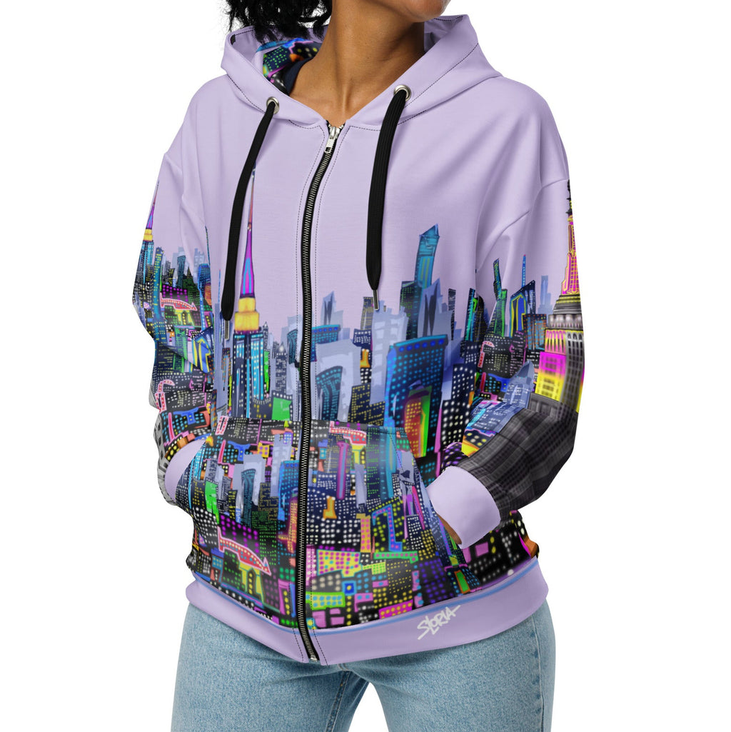 Woman wearing a hoodie with a colorful cityscape Loria NYC Art design on a white background
