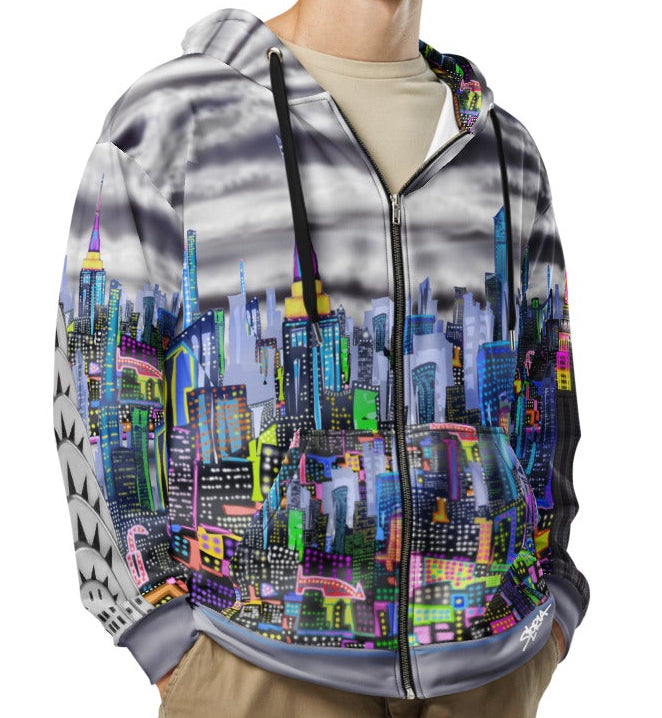 Person wearing a colorful Loria NYC Art cityscape hoodie and beige cargo pants on a white background