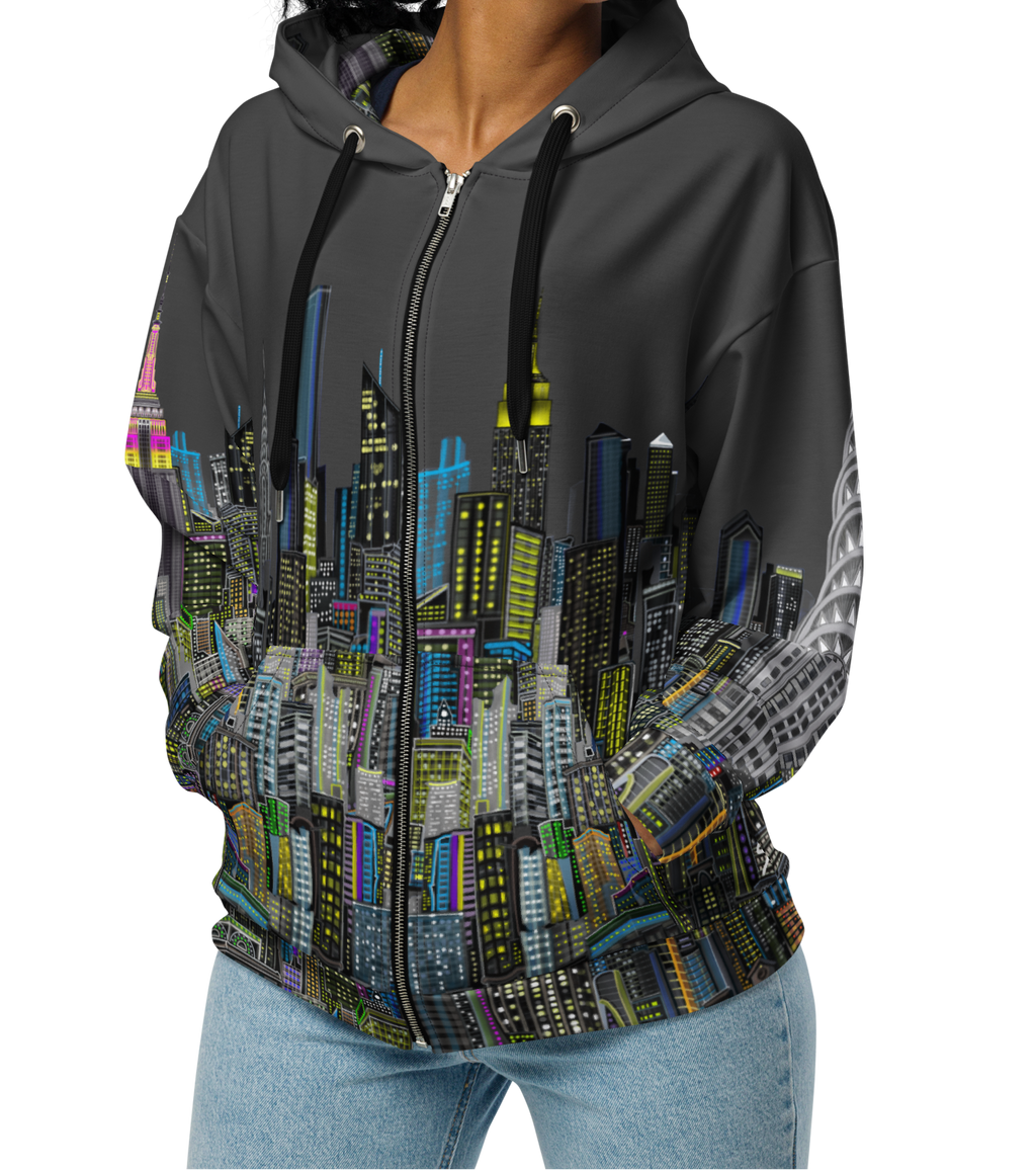 Woman wearing a gray hoodie with a colorful Loria NYC Art cityscape design on a white background