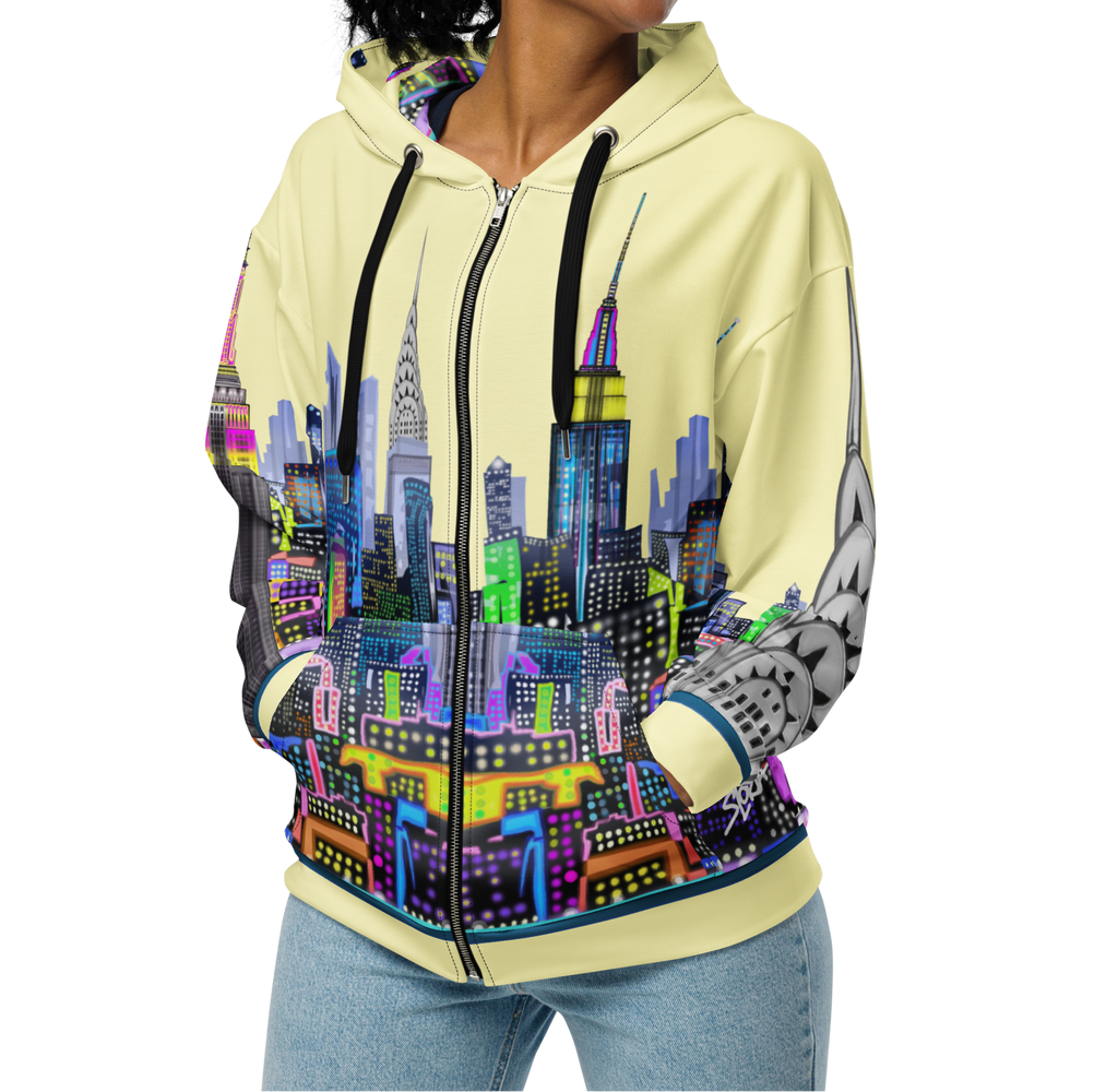 Woman wearing a Loria NYC Art hoodie with a colorful cityscape design on a white background