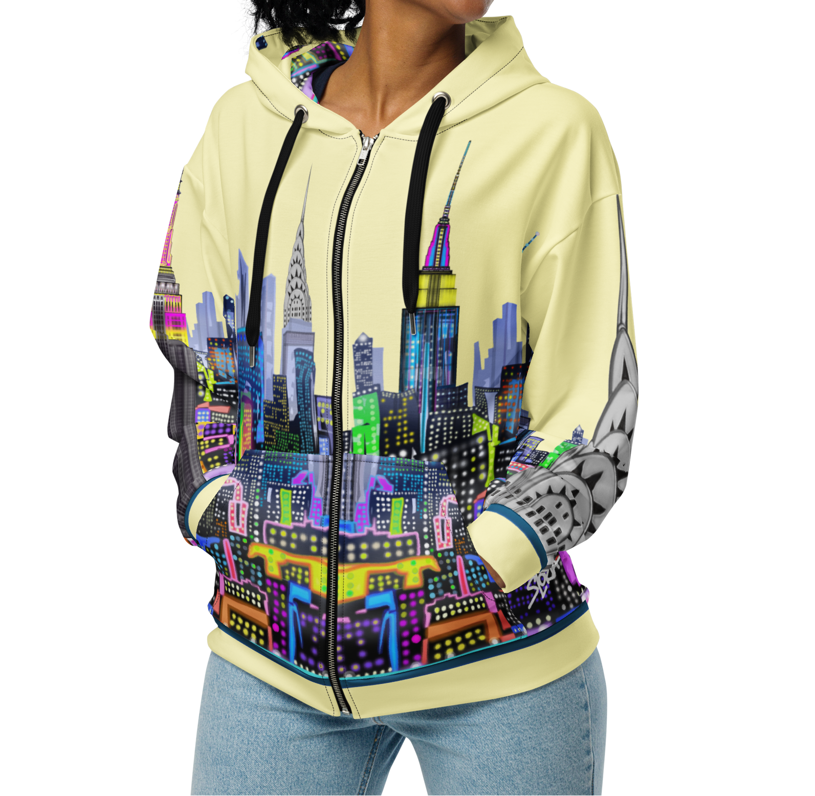 Woman wearing a Loria NYC Art hoodie with a colorful cityscape design on a white background