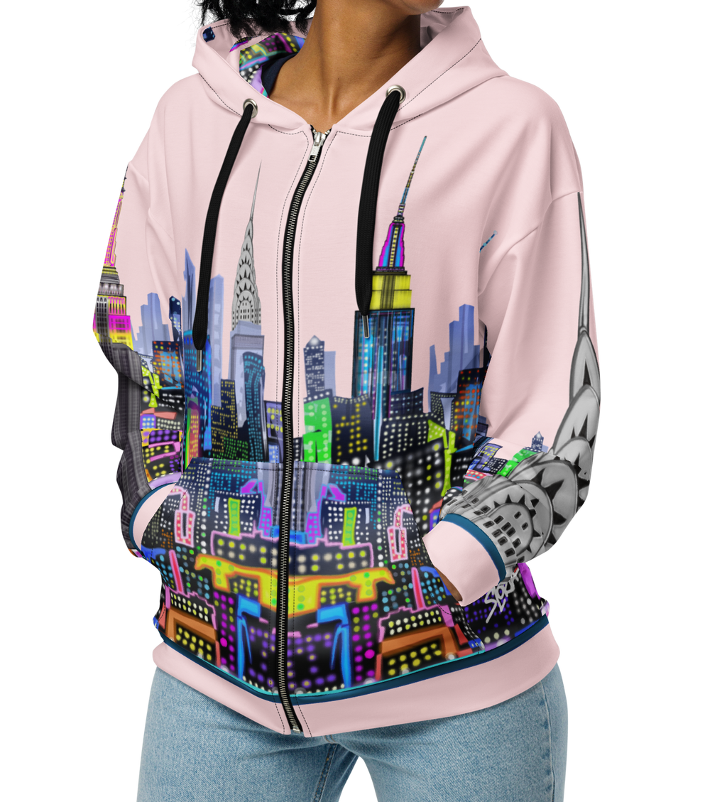Person wearing a pink hoodie with a colorful cityscape Loria NYC Art design on a white background