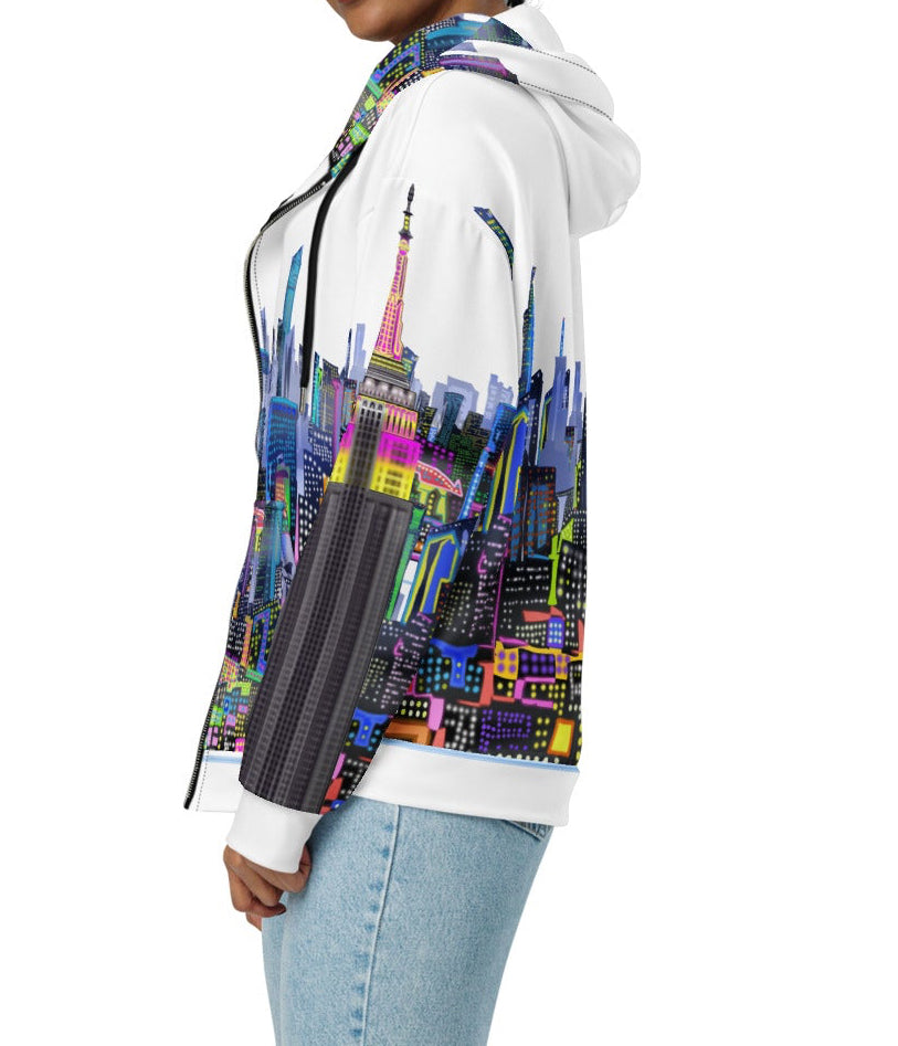 Person wearing a hoodie with a colorful Loria NYC Art cityscape design on a white background