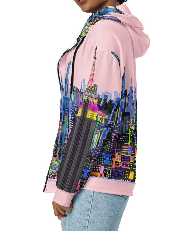Person wearing a colorful hoodie with a cityscape Loria NYC Art design on a white background