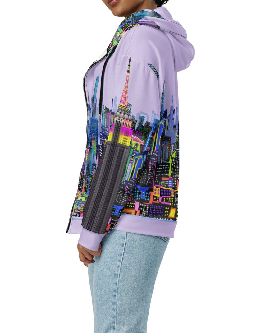 Person wearing a colorful  Loria NYC Art hoodie with a cityscape design on a white background