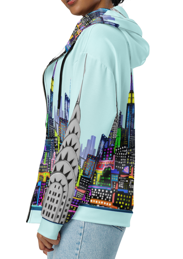 Person wearing a colorful Loria NYC Art hoodie with a cityscape design on a white background