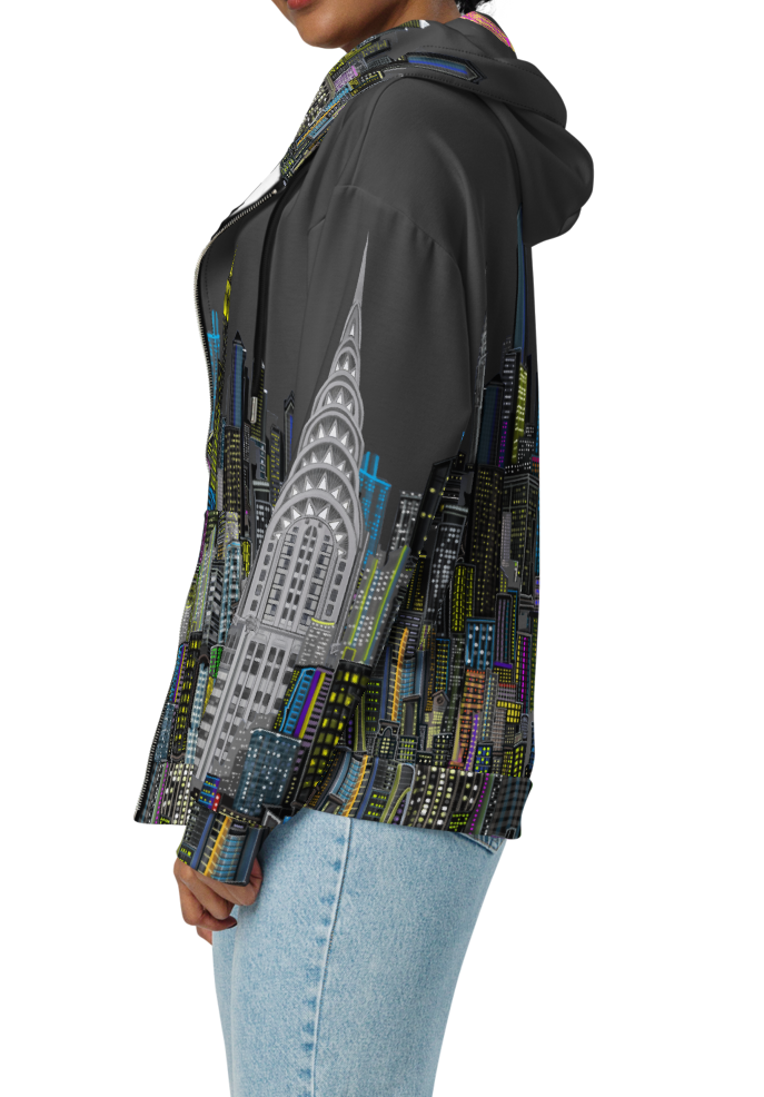 Woman wearing a hoodie with a Loria NYC Art cityscape design on a white background