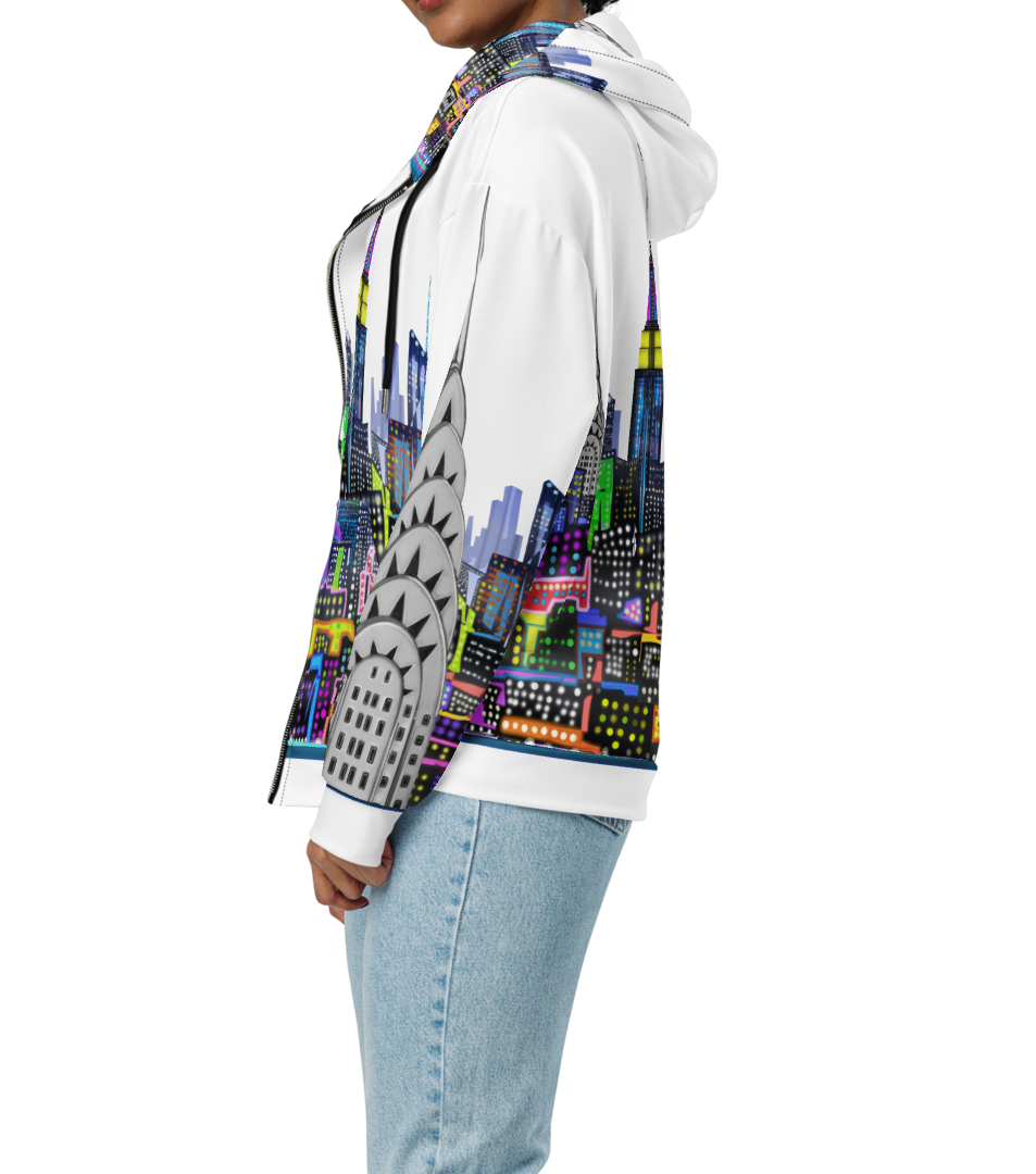 Person wearing a hoodie with a colorful cityscape Loria NYC Art design on a white background