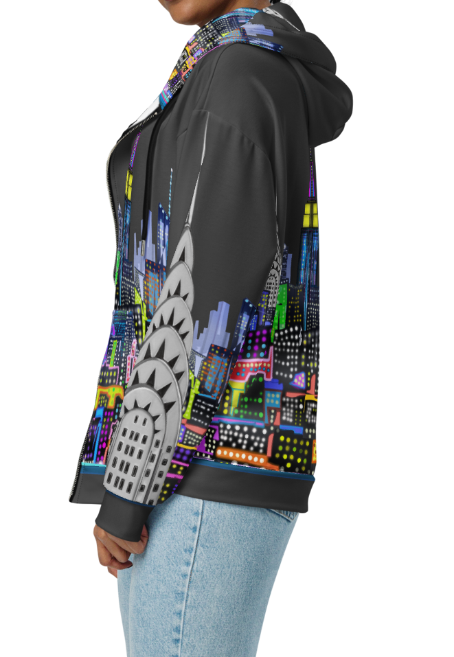 Woman wearing a Loria NYC Art colorful hoodie with a cityscape design on a white background