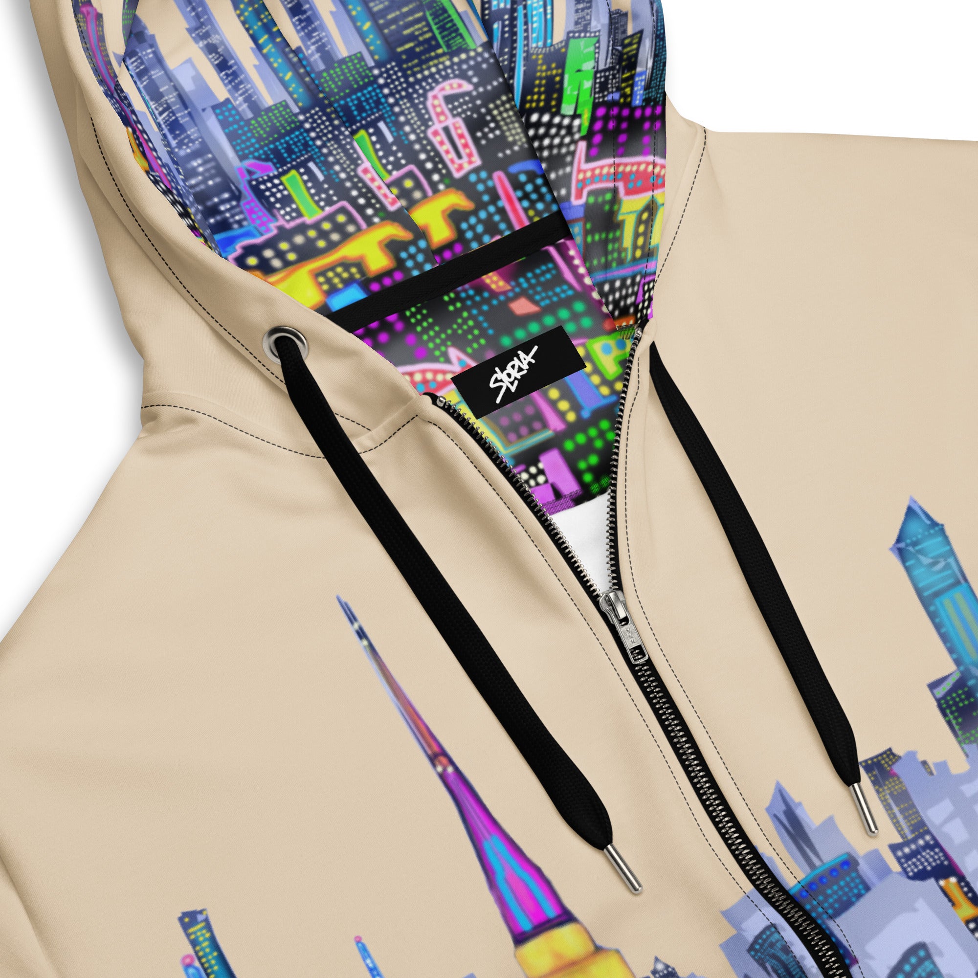 Beige hoodie with colorful Loria NYC Art cityscape design on the hood and front, featuring a brand logo.