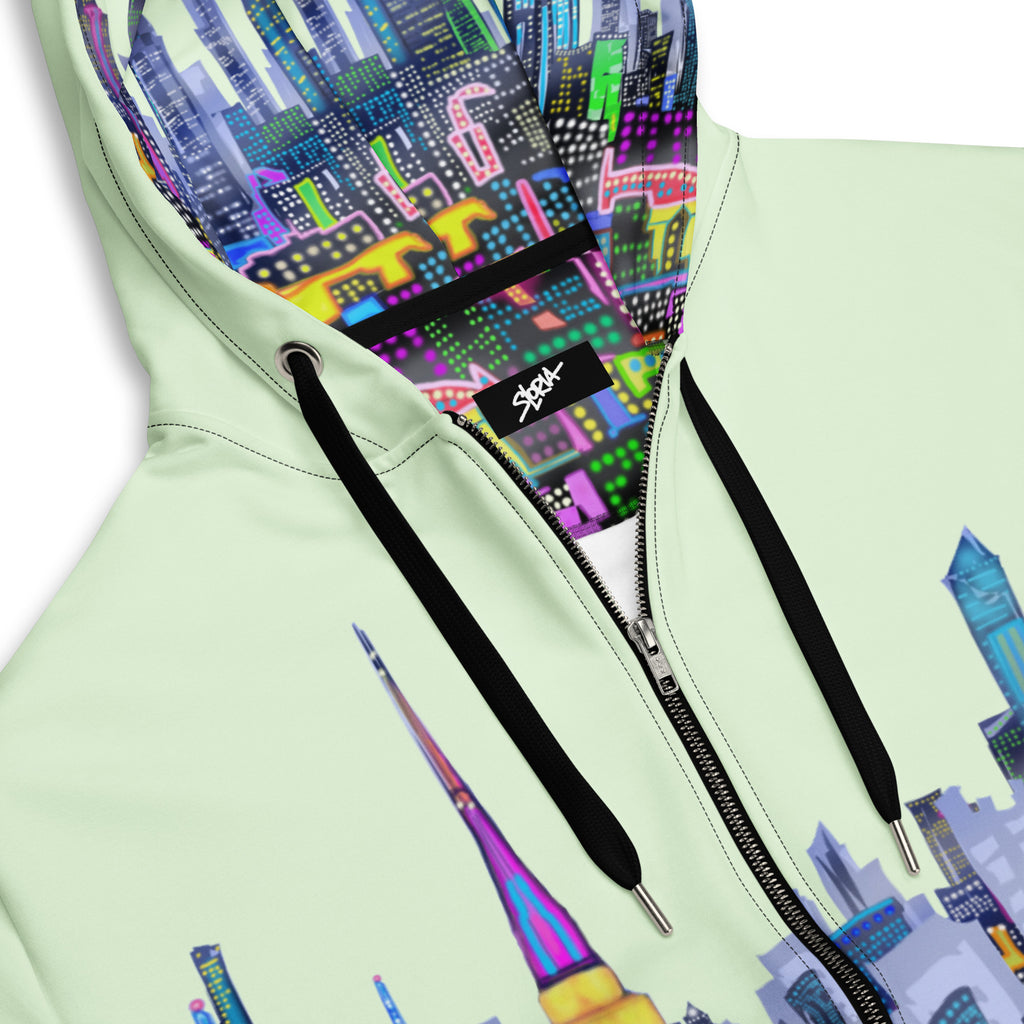 Light green hoodie with colorful Loria NYC Art cityscape design on the hood and front, featuring a brand logo.