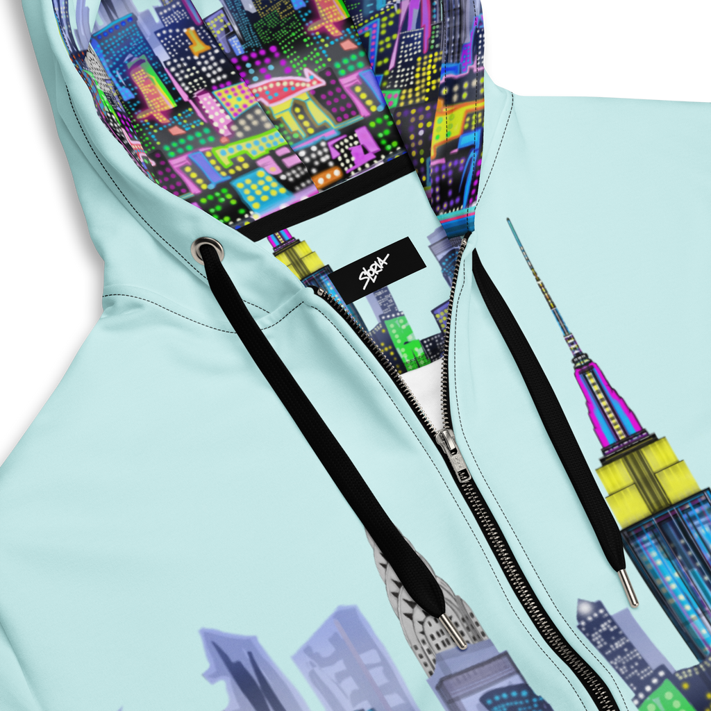Light blue hoodie with colorful cityscape Loria NYC Art design and SLoria logo.