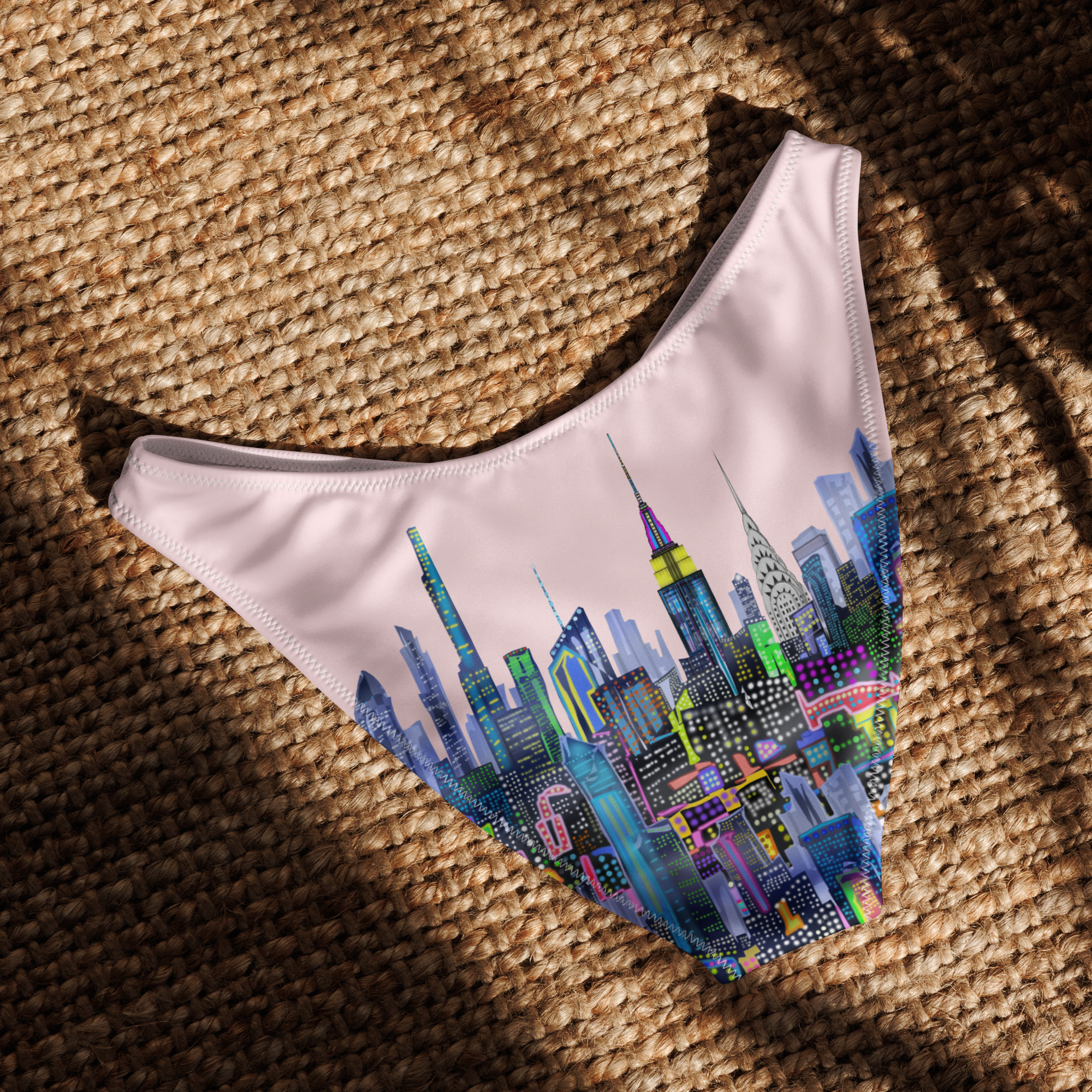 Colorful cityscape Loria NYC Art design on a pink background laid flat on a textured surface