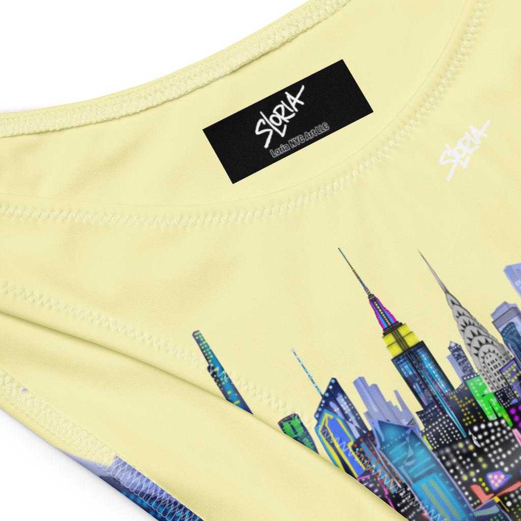Light yellow fabric with colorful Loria NYC Art cityscape design and 'SLoria ' brand label.