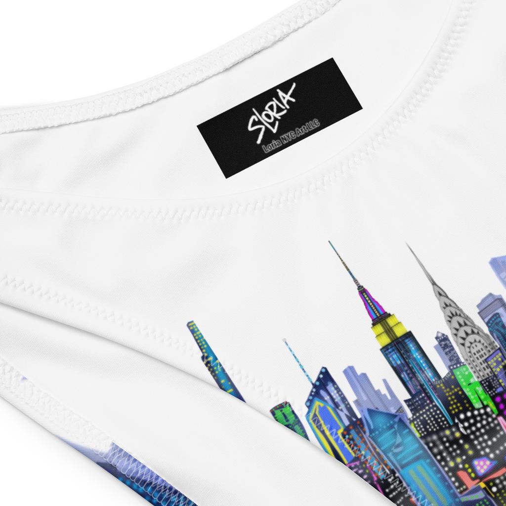 Close-up of a white Loria NYC Art with a colorful cityscape design and a black label on a white background.
