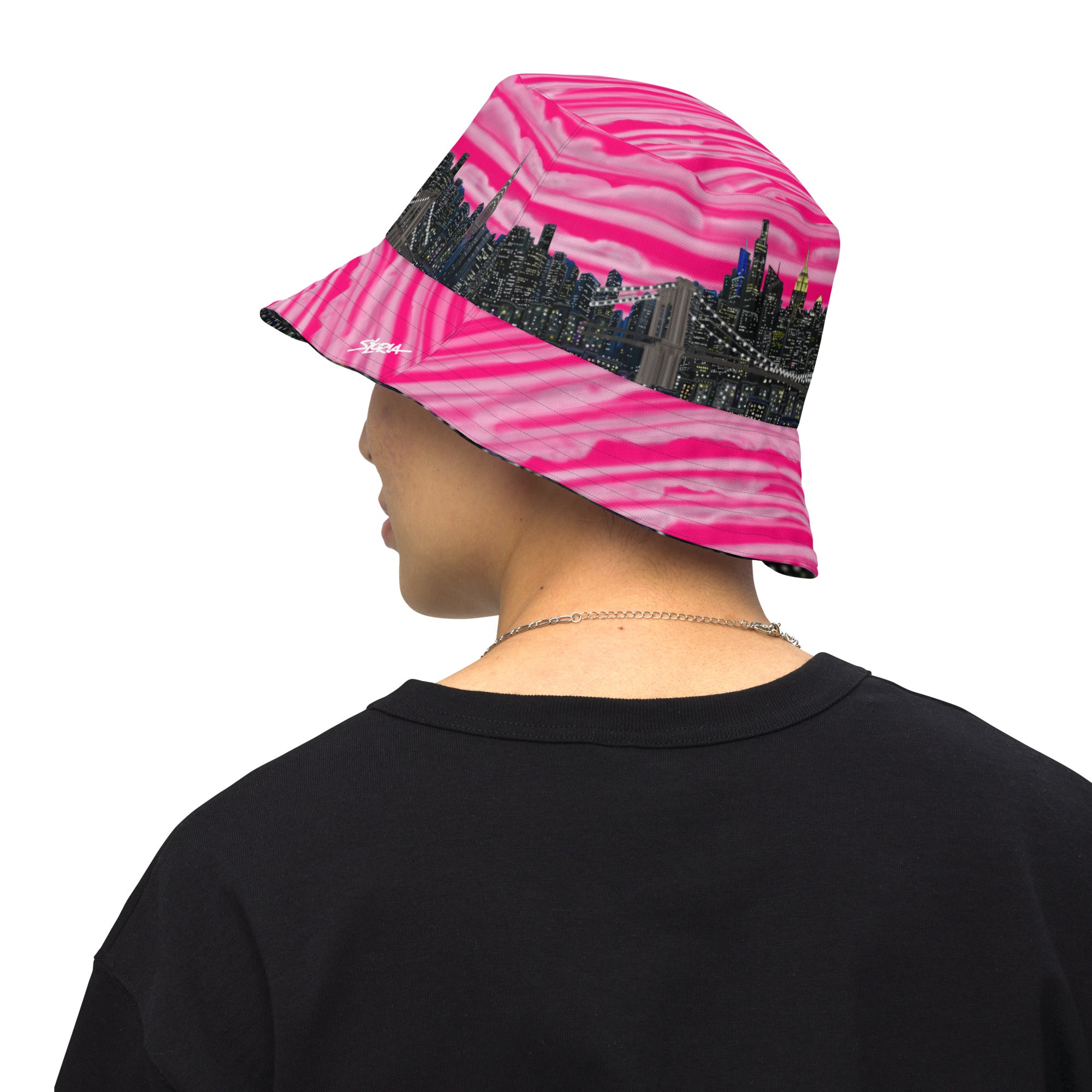 Man wearing  Reversible Bucket Hat with Città Rosa Vento Fuchsia NYC skyline designed with Brooklyn bridge by S.Loria NYC