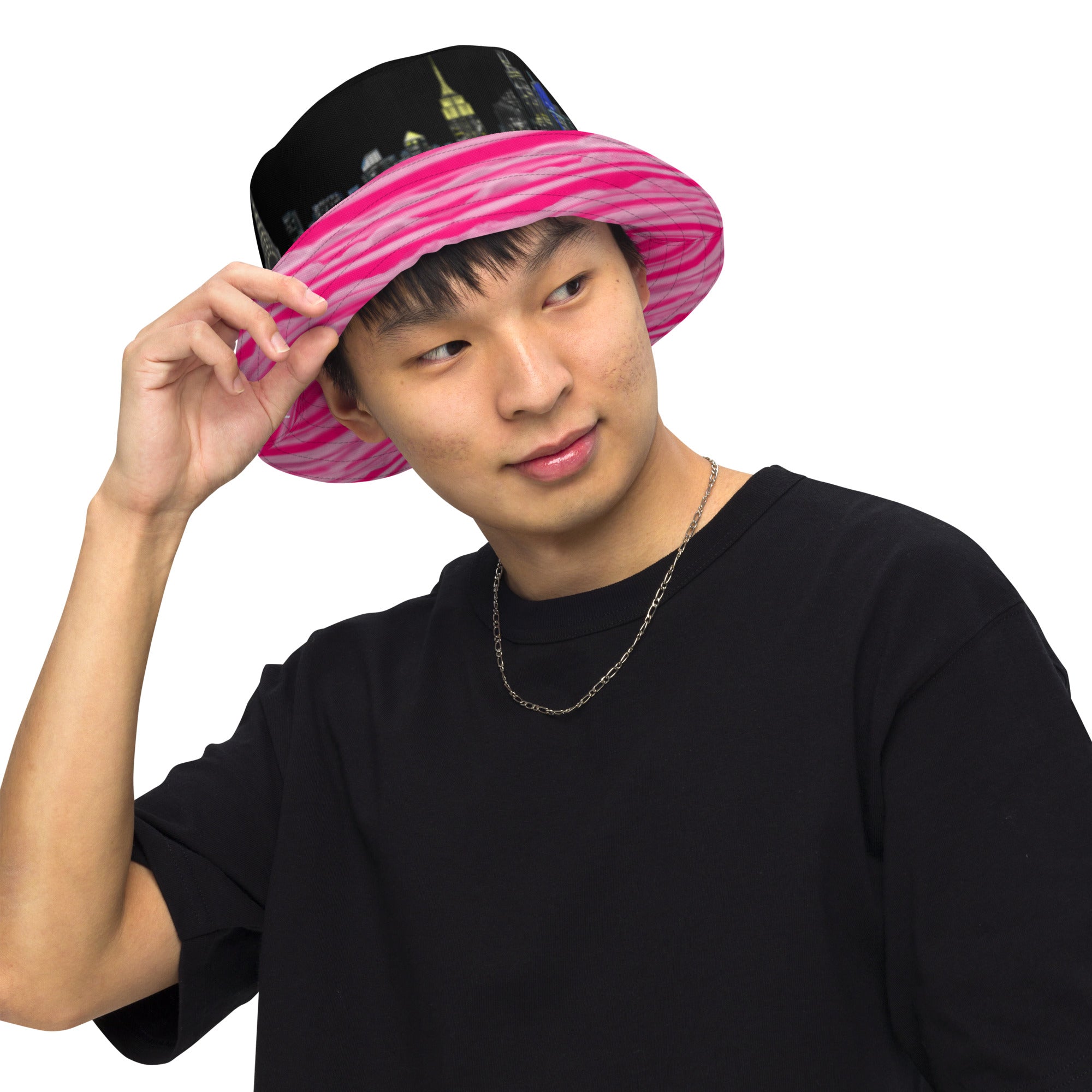 Man wearing  Reversible Bucket Hat with Città Rosa Vento Fuchsia NYC skyline designed by S.Loria NYC