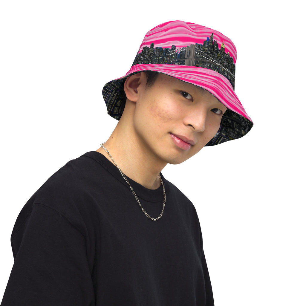 Man wearing  Reversible Bucket Hat with Città Rosa Vento Fuchsia NYC skyline designed with Brooklyn bridge by S.Loria NYC