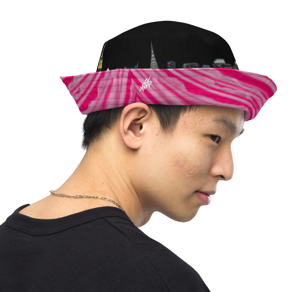 Man wearing  Reversible Bucket Hat with Città Rosa Vento Fuchsia NYC skyline designed with Brooklyn bridge by S.Loria NYC