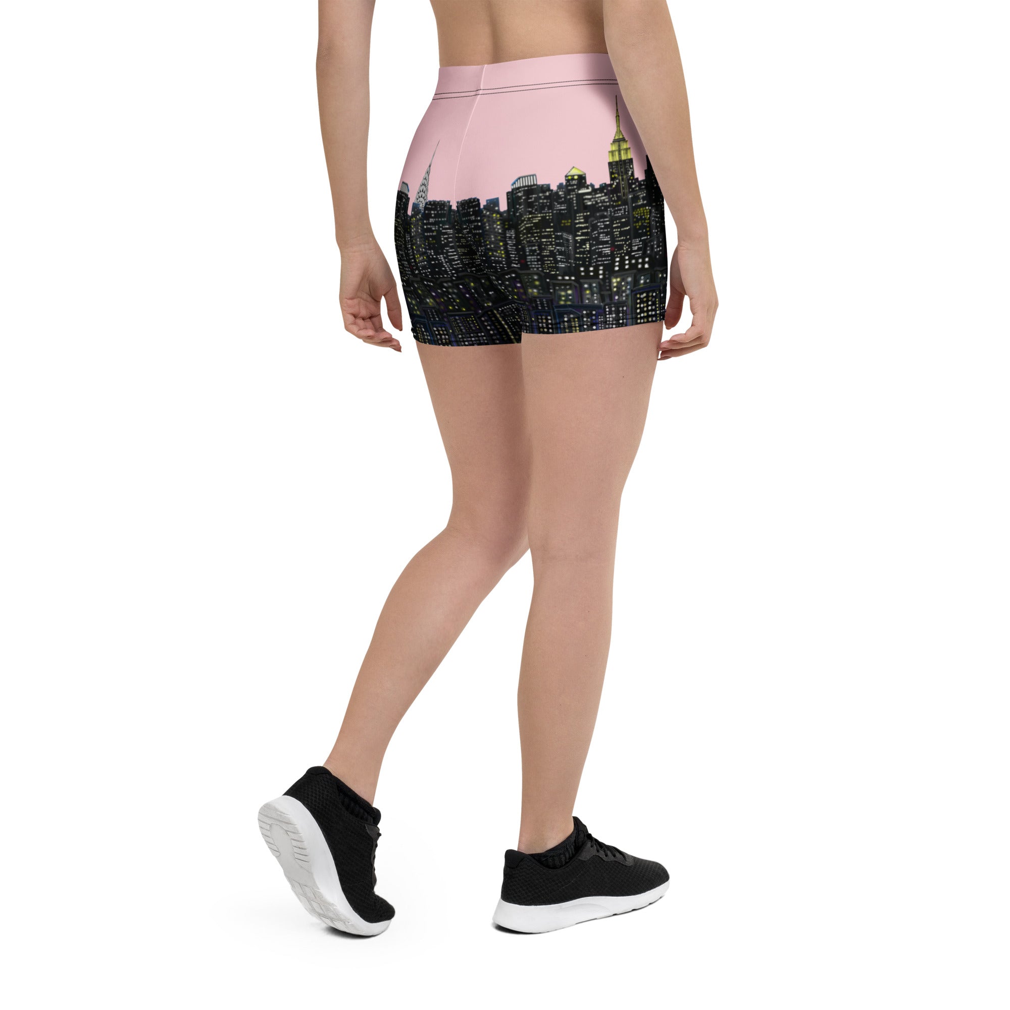 Person wearing black shorts with cityscape Loria NYC Art design on a white background