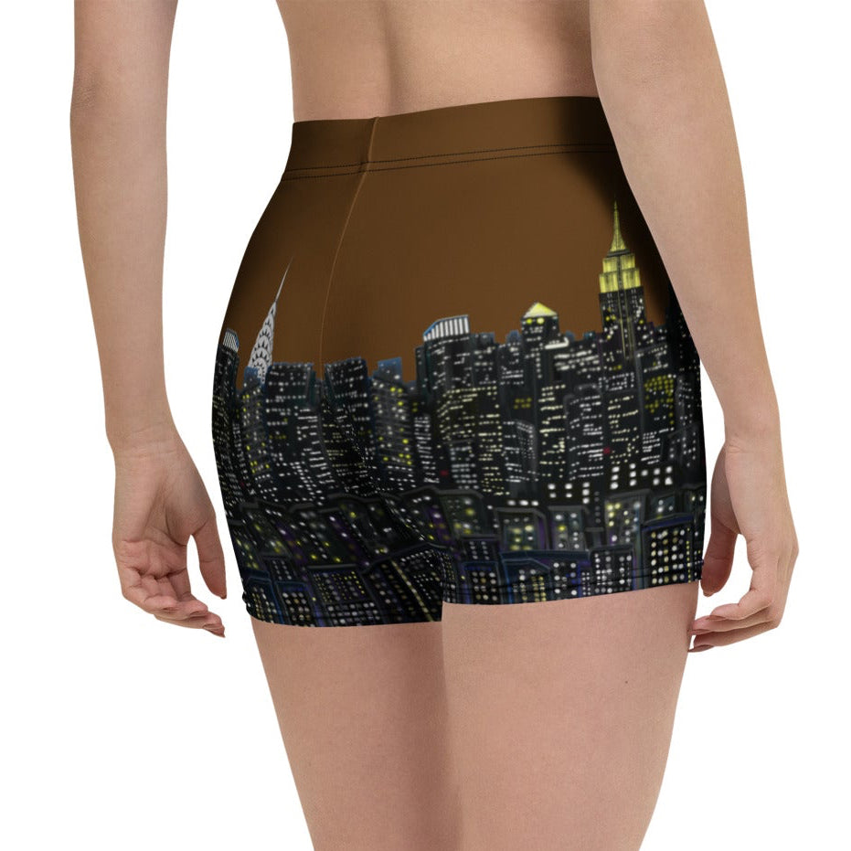 Person wearing a pair of shorts with a cityscape Loria NYC Art design on a white background