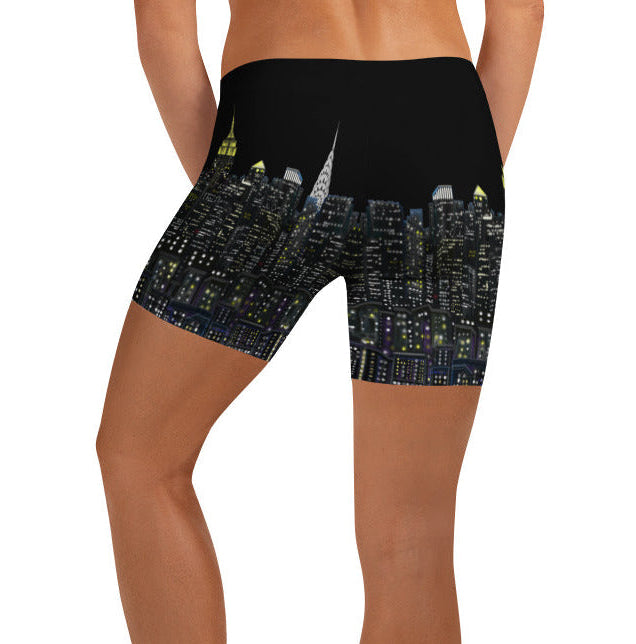 Person wearing black shorts with cityscape Loria NYC Art design on a white background