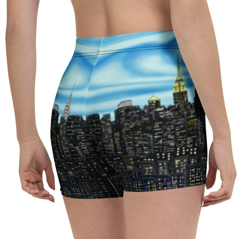 Person wearing shorts with a Loria NYC Art cityscape design on a white background