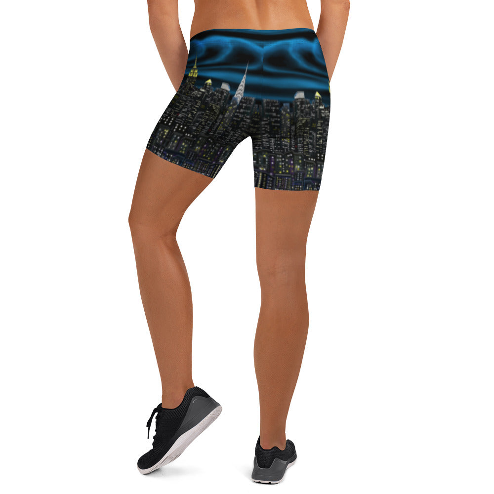 Person wearing blue athletic shorts with a cityscape Loria NYC Art design on a white background
