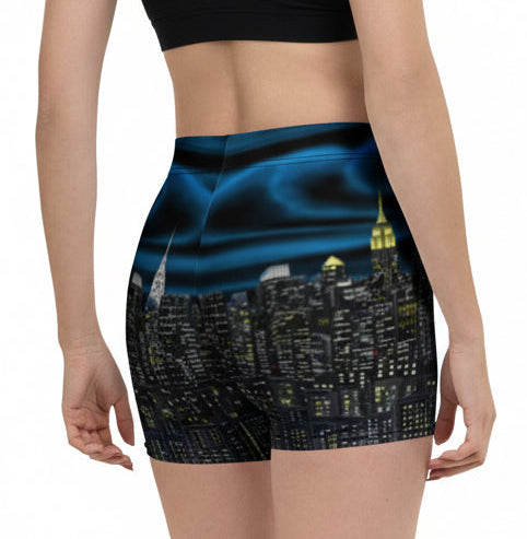Person wearing Loria NYC Art shorts with a cityscape design on a white background
