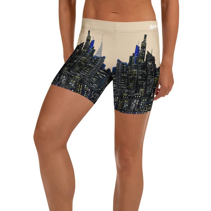 Person wearing shorts with a Loria NYC Art cityscape design on a white background