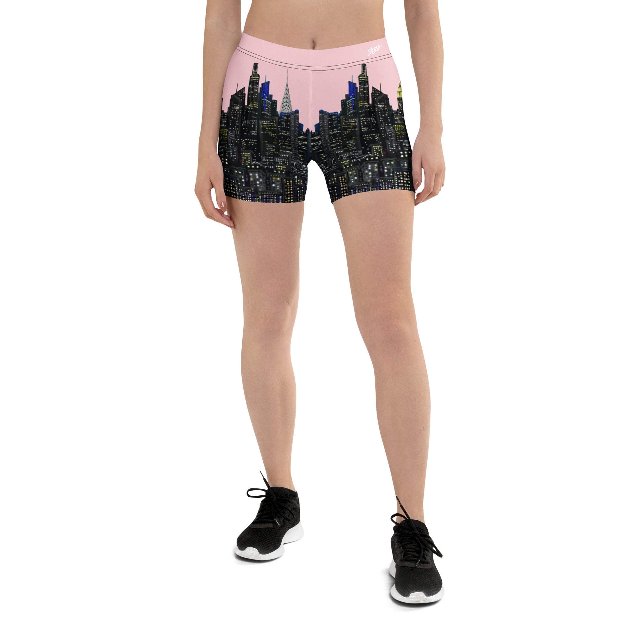 Person wearing shorts with a Loria NYC Art cityscape design on a white background