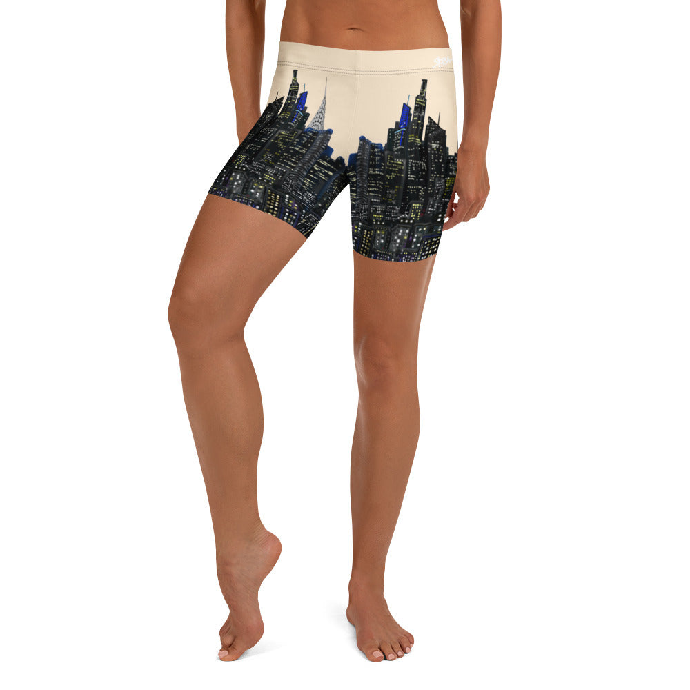 Person wearing Città Papaya shorts with a Loria NYC Art skyline design on a white background