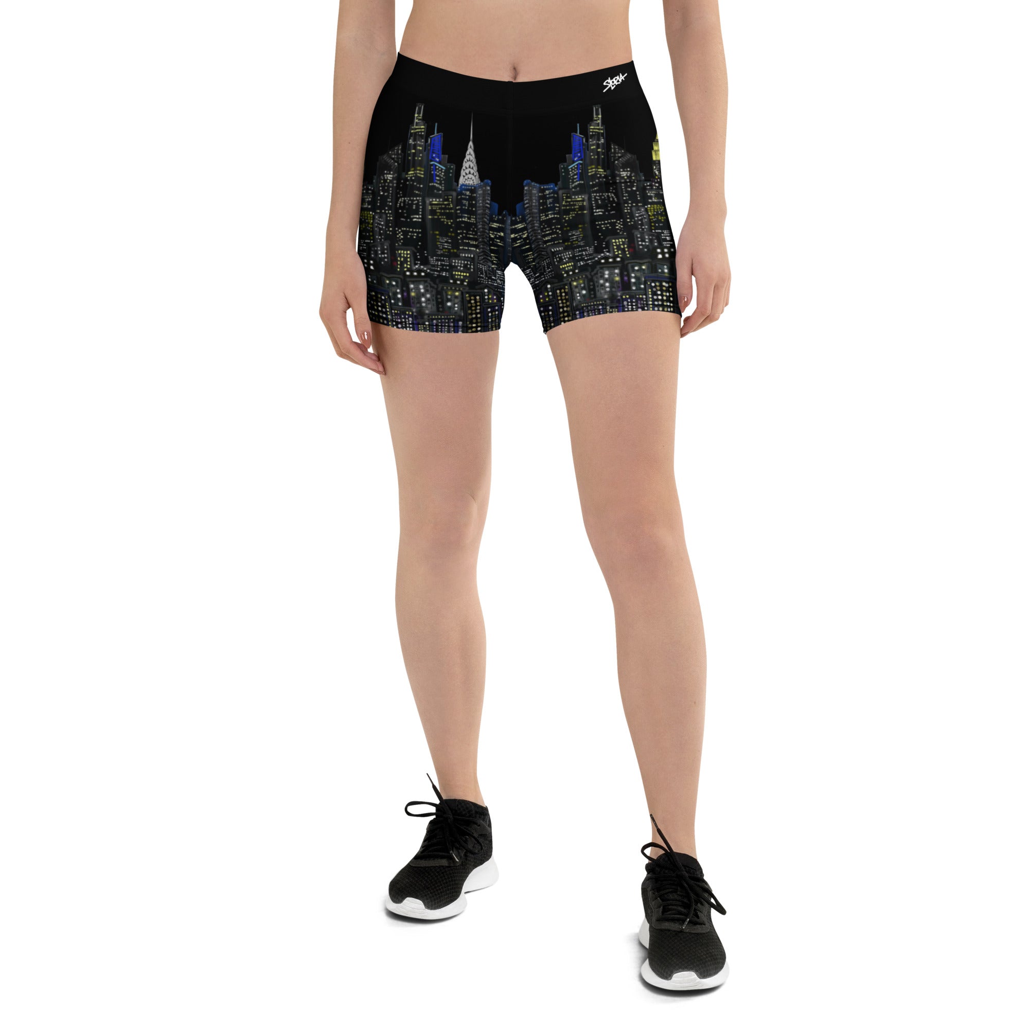 Person wearing black shorts with a cityscape Loria NYC Art design on a white background