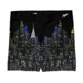 Black swim briefs with a cityscape design on a white background